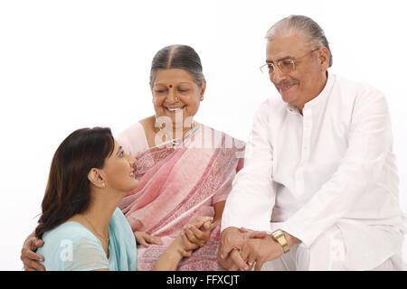 Young woman sitting down looking at old parent MR#703P,703Q,703S Stock Photo