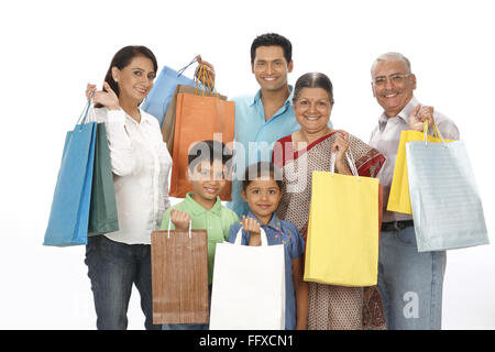 Parent children with grandparent showing colourful shopping bags MR#703N,703O,703P,703Q,703R,703S Stock Photo