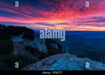 Awesome colorful sunset over the mountain hills Stock Photo