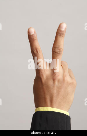 Businessman showing close up of hand with two Index and middle finger Stock Photo