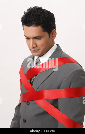 Businessman tied with red ribbon MR#703T Stock Photo