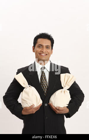 Businessman holding money bag in both hands MR#703T Stock Photo