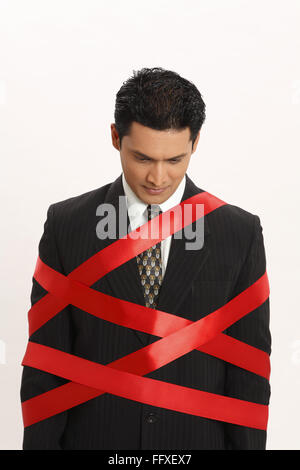 Businessman tied with red ribbon MR#703T Stock Photo