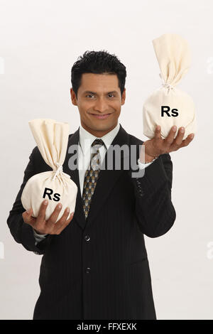 Businessman holding money bags in both hands MR#703T Stock Photo