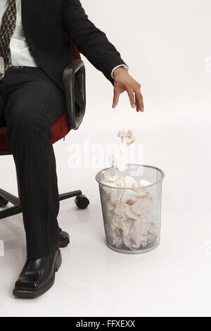 Businessman throwing paper ball in paper basket MR#703T Stock Photo