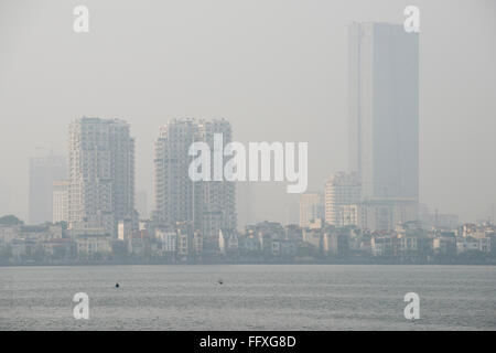 Mist, fog or smog pollution in a hazy skyline of Hanoi viewed over Westlake, Vietnam, January