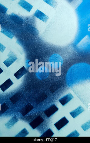 Abstract geometrical pattern sprayed with blue paints on a textured surface. Taken in vertical format. Stock Photo
