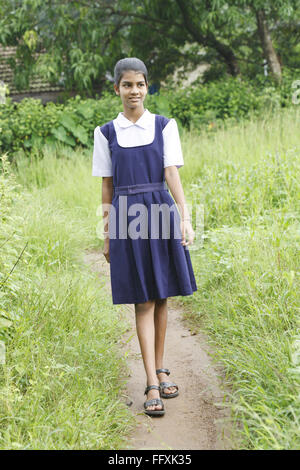 School going girl walking on pathway , Maharashtra , India MR#703Z Stock Photo