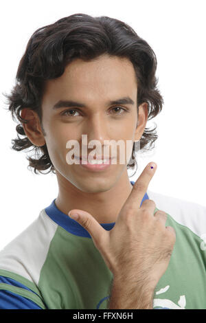 Teenage boy pointing thumb and index finger like gun shape showing voting mark MR#687T Stock Photo