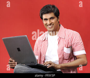 South Asian Indian man using laptop , India MR#732A Stock Photo