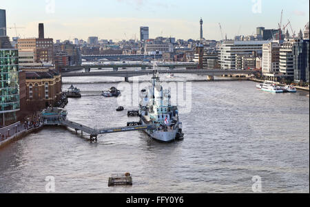 HMS Belfast on the river Thames in London City with London Bridge in the background Stock Photo