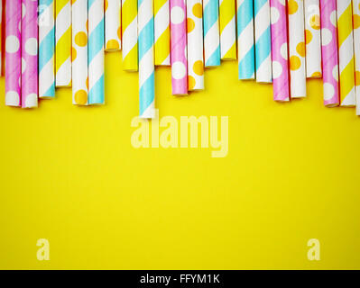 High Angle View Of Colorful Straws Against Yellow Background
