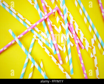 High Angle View Of Colorful Straws Against Yellow Background
