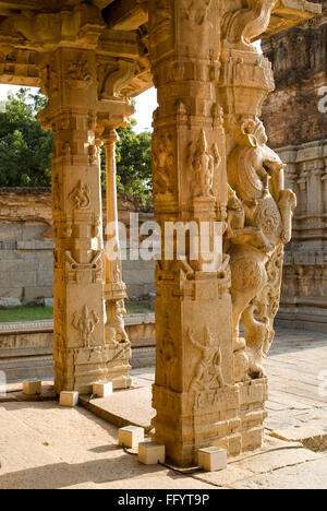 View of intricately carved monolithic pillars in Kalyana Mandap , Vittala temple , Hampi , Karnataka , India Stock Photo