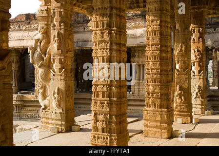 View of intricately carved monolithic pillars in Kalyana Mandap , Vittala temple , Hampi , Karnataka , India Stock Photo