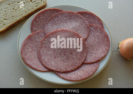 Salami sausage on a plate Stock Photo