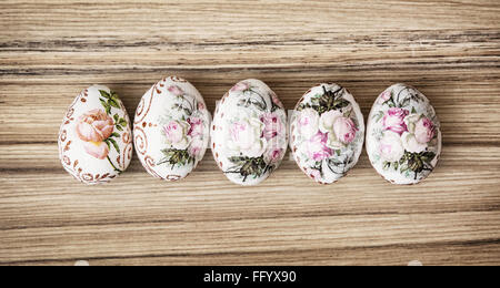 Five Easter eggs on the wooden background. Easter holiday. Symbol of springtime. Stock Photo
