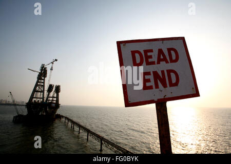 A dead end placard at the construction site of the Bandra Worli Sea link Arabian Sea Western suburb Bombay Mumbai Maharashtra Stock Photo