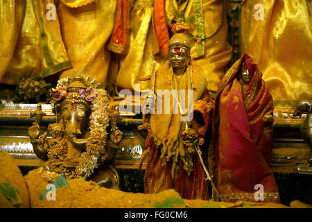 Brass idol of lord Khandoba and his wife with Ganpati at the  Jejuri temple , pune , Maharashtra , India Stock Photo
