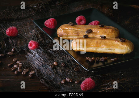 Coffe eclair with raspberries Stock Photo