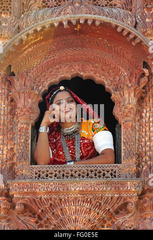 Rajasthani lady looking through jharoka ; Rajasthan ; India MR#769C Stock Photo