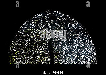 Jali work depicting palm trees with curved tendrils on windows of Sidi Sayed mosque in Ahmedabad ; Gujarat ; India Stock Photo