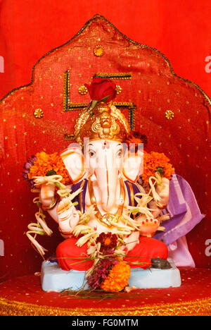 Richly decorated idol of lord Ganesh elephant headed god for Ganpati festival at Shree Ram Temple Tulsibag Pune Maharashtra Stock Photo