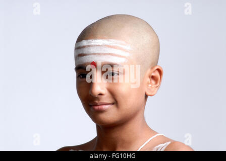 Indian Hindu bald boy with red tilak white shaivite symbol on forehead India MR#719 Stock Photo