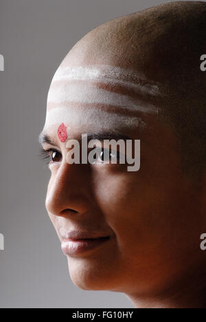 Indian Hindu bald boy with red tilak white shaivite symbol on forehead India MR#719 Stock Photo