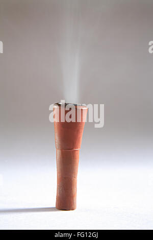 Concept , clay cilam contains fire and tobacco for smoke equipment on white background Stock Photo