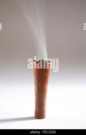 Concept , clay cilam contains fire and tobacco for smoke equipment on white background Stock Photo