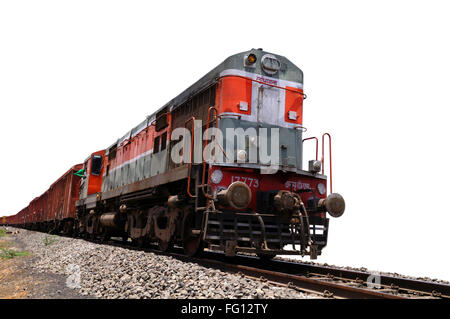 Goods train engine on railway track against white background of sky India Stock Photo