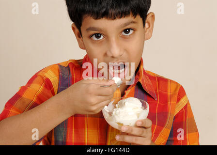 South Asian Indian boy eating ice cream , India MR#152 Stock Photo