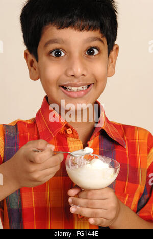 South Asian Indian boy eating ice cream , India MR#152 Stock Photo