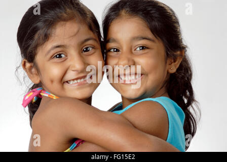 South Asian Indian two girls hugging each other and smiling MR#364 Stock Photo