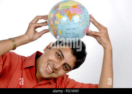 South Asian Indian man holding globe on his head looking at camera MR# 628