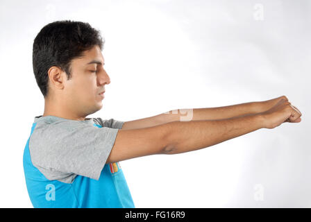 South Asian Indian man doing exercise closing eyes both hand to stretching to left side MR#628 Stock Photo