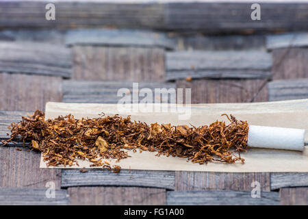 Tobacco in rolling paper with a slim filter Stock Photo