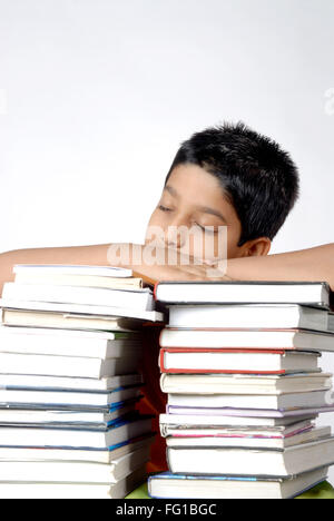 Boy resting on both hands kept on stack of books MR#152 Stock Photo