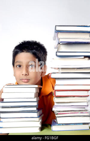 Boy touching chin on stack of books MR#152 Stock Photo