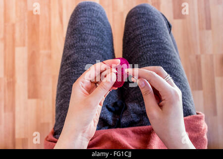 Girl making crochet circles for jewelry elements Stock Photo