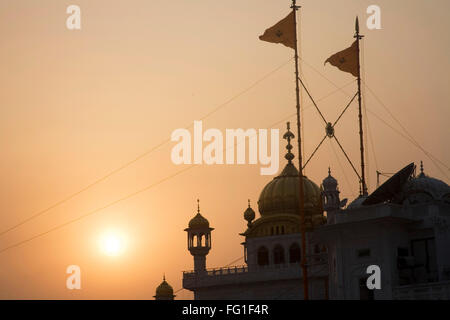 Akal takht flag during sunset swarn mandir or golden temple , Amritsar , Punjab , India Stock Photo