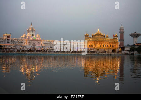 Illuminated Harimandir Sahib swarn mandir or golden temple reflection in pond , Amritsar , Punjab , India Stock Photo