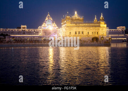 Illuminated Harimandir Sahib swarn mandir or golden temple during Dussera festival , Amritsar , Punjab , India Stock Photo