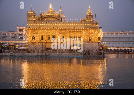 Illuminated Harimandir Sahib swarn mandir or golden temple during Dussera festival , Amritsar , Punjab , India Stock Photo