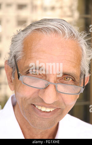 Sixty four year old man wearing spectacles inquiringly smiling MR#686N Stock Photo