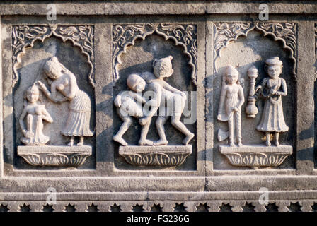 Relief or panel of wrestler and bathing scene man woman servant carved in stone wall Maheshwar temple Maheshwar Madhya Pradesh Stock Photo