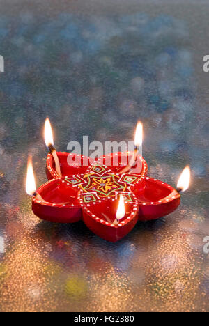 Decorated red color oil lamp used in Diwali deepawali festival Stock Photo