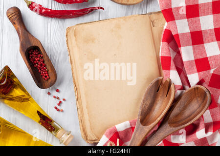 Blank vintage recipe cooking book, utensils and ingredients on wooden table. Top view with copy space Stock Photo