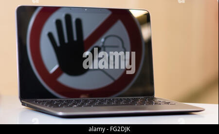 Stop sign in Notebook screen. Concept of stopping tinternet crime. Stock Photo